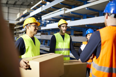 Workers talking in factory warehouse