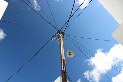 Low angle view of power lines against sky