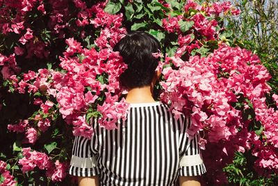 Woman holding pink flower