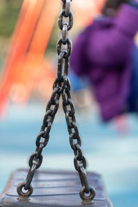 Close-up of chain swing at playground