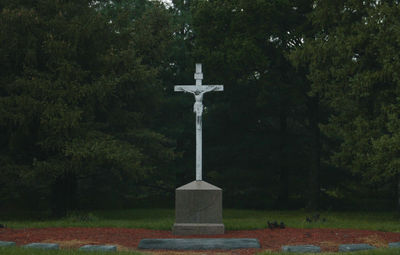 Statue of cemetery against trees