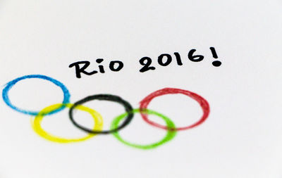 High angle view of text and olympic rings drawn on paper