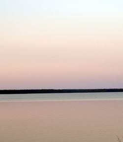 Scenic view of sea against clear sky during sunset