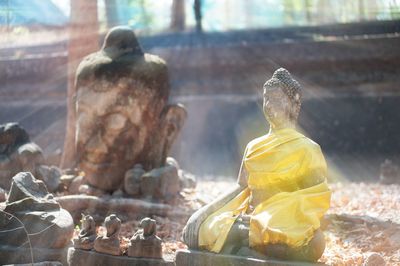 View of buddha statues on field