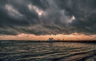 Scenic view of sea against dramatic sky