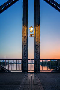 Bridge over sea against sky during sunset