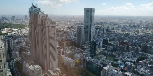 High angle view of modern buildings in city against sky