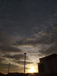 Low angle view of silhouette buildings against sky during sunset