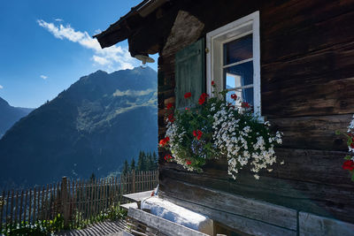 Building by mountain against sky