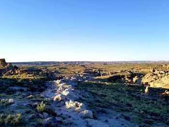 Scenic view of land against clear blue sky