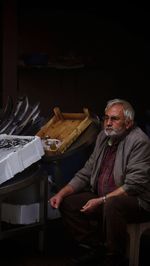 Full length of man sitting on table