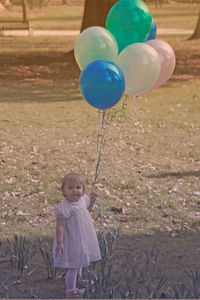 Cute girl holding balloons