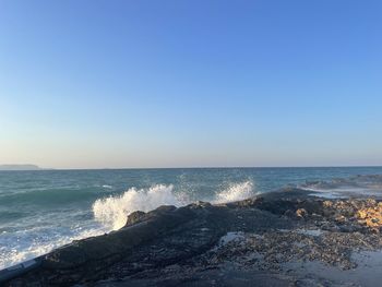 Scenic view of sea against clear blue sky