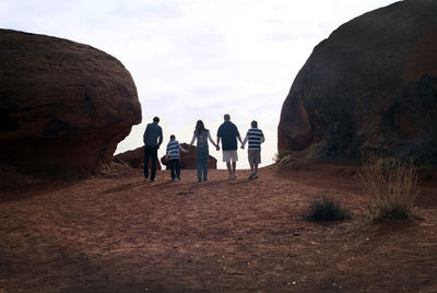 People standing on rock formation