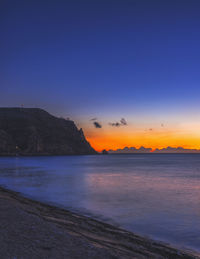 Scenic view of sea against clear sky during sunset