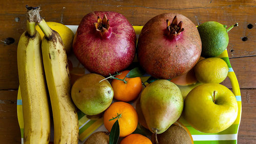 High angle view of various fruits in a disk on table