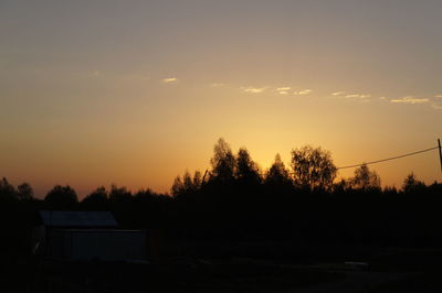 Silhouette trees against sky during sunset