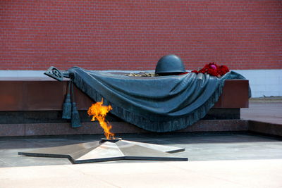 View of memorial statue against wall