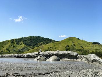 Scenic view of mountain against blue sky