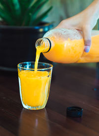 Close-up of orange juice on table