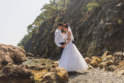 Young couple kissing on rock