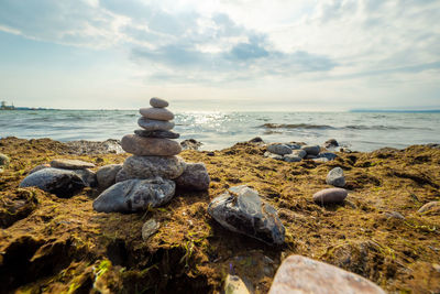 Rocks on beach against sky