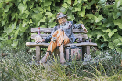 Portrait of man sitting on seat in field
