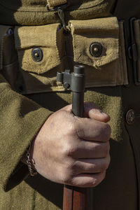 Close-up of army soldier holding gun