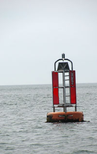 Lifeguard hut on sea against clear sky