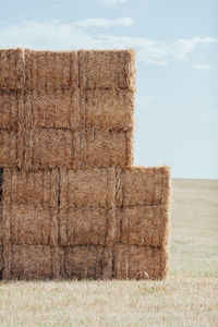 Stack of hay bales on field