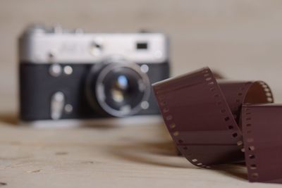 Close-up of film reel by camera on table