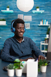 Portrait of young man sitting at table