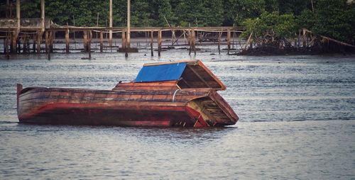 Abandoned boat moored at beach