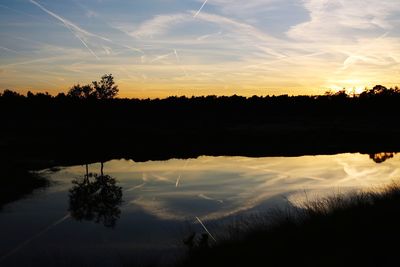 Scenic view of silhouette trees against sky during sunset