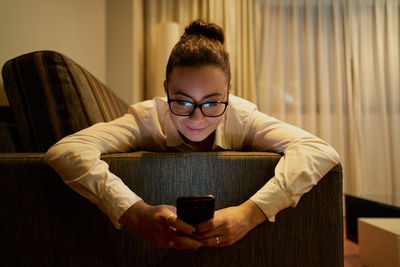 Young woman working with laptop in evening