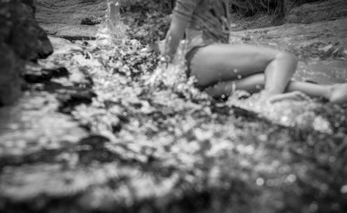 Low section of woman in water