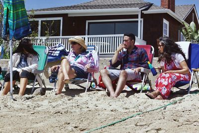 Friends sitting on sand