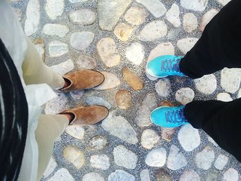 Low section of man standing on tiled floor