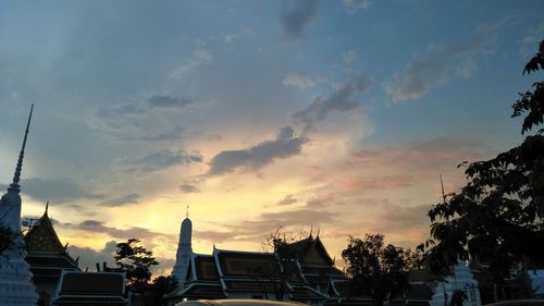 Low angle view of silhouette buildings against sky during sunset