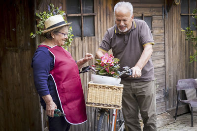 Couple with bicycle outside house