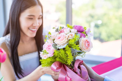 Young woman holding flower bouquet