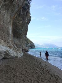 People on beach against sky