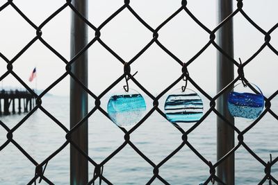 Close-up of chainlink fence against sky