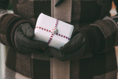 Midsection of woman holding christmas present