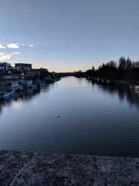 Scenic view of lake by buildings against sky