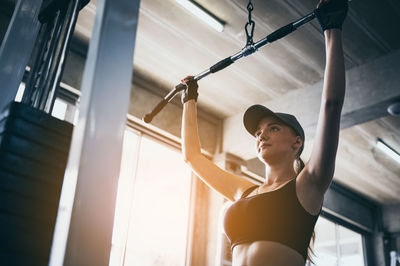 Low angle view of woman standing against wall