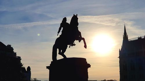 Low angle view of statue against sky during sunset