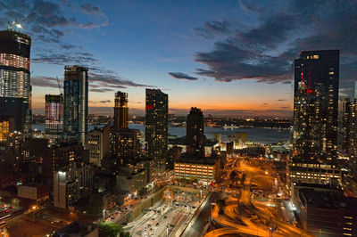 Illuminated cityscape against sky at night