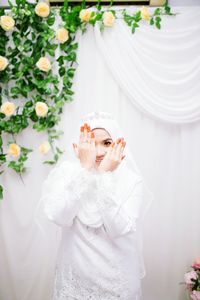 Woman holding white flowers in pot