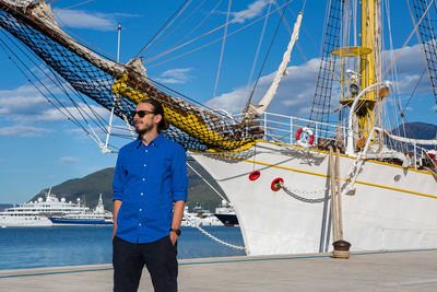 Low angle view of man standing on ship